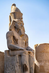 Carved sitting statue of king. luxor.