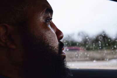 Close-up of bearded man sitting in car