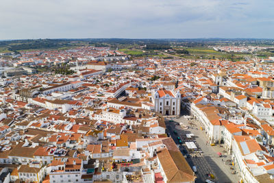 Evora drone aerial view on a sunny day with historic buildings city center in alentejo, portugal