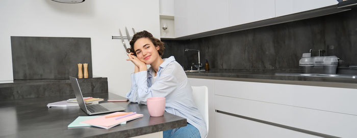 Young woman using mobile phone in cafe