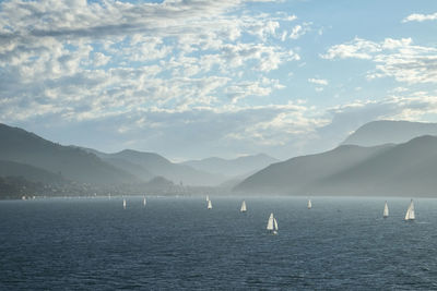 View of calm sea against mountain range