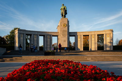 Statue of flowering plants in front of building