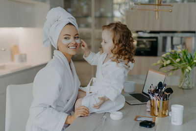 Smiling mother with daughter at home