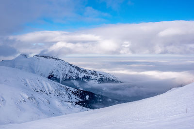 Scenic view of snow covered landscape against sky