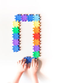 Low section of person with toy against white background