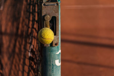 Tennis ball on pole of net