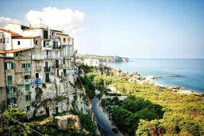 High angle view of old buildings by sea against sky