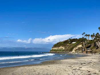 Scenic view of beach against blue sky