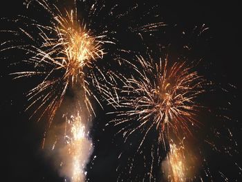 Low angle view of firework display at night