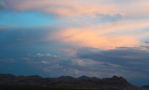 Low angle view of mountains against dramatic sky