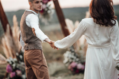 Rear view of couple standing outdoors