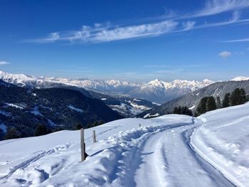 Scenic view of snowcapped mountains against blue sky