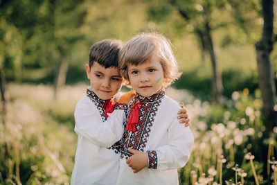 Brothers standing in park