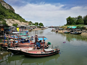 Boats moored on river against sky