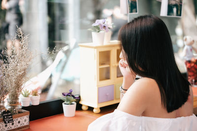 Rear view of woman at home