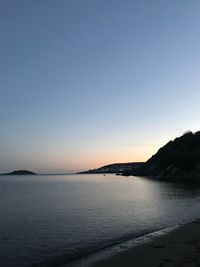 Scenic view of sea against clear sky during sunset