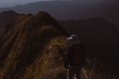 Rear view of man standing on mountain