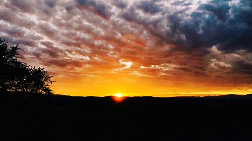 Scenic view of silhouette landscape against sky at sunset