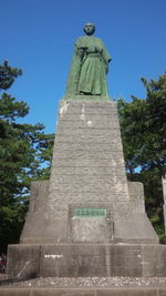 Low angle view of statue against sky