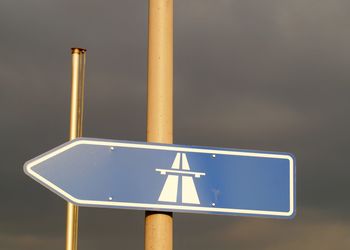 Low angle view of road sign against pole