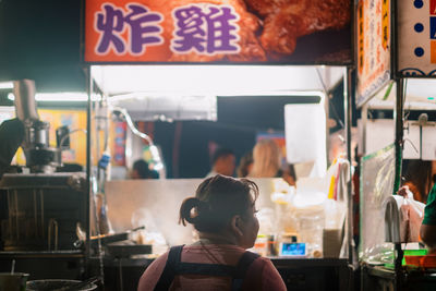 Rear view of people standing in restaurant