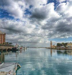 Pier on sea against cloudy sky