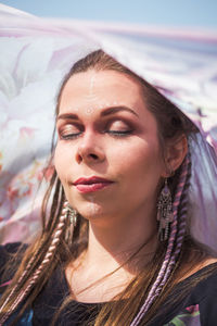 Close up woman with tribal makeup and thin fabric portrait picture