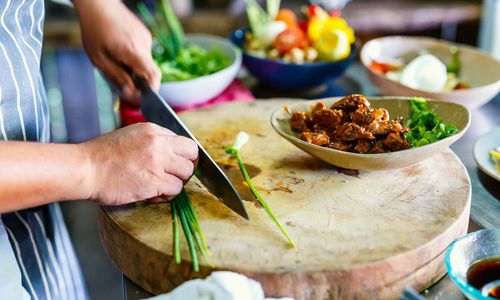 Cropped hand of person preparing food