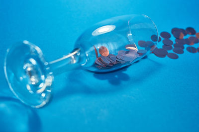 High angle view of blue drinking glass on table