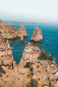 Mountains by sea against clear sky