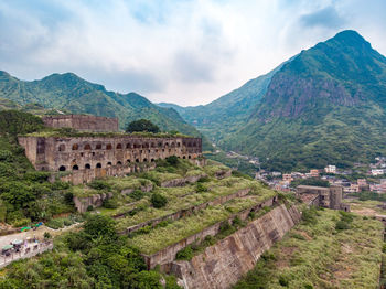 Scenic view of mountains against cloudy sky