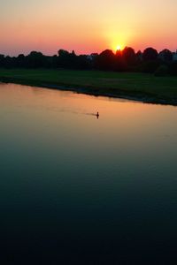 Scenic view of lake against sky during sunset