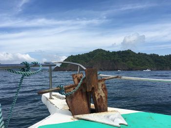 Boat sailing in sea against sky