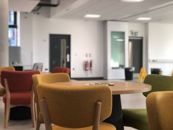 Empty chairs and table in room