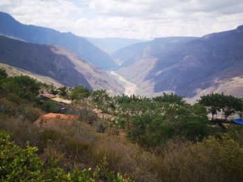 Scenic view of landscape and mountains against sky