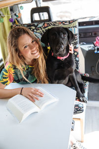 Woman traveling with dog in camper van