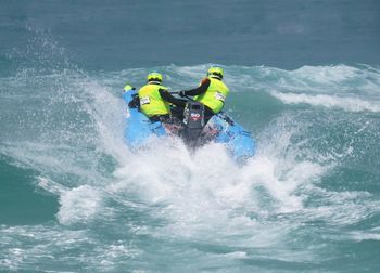 Men on inflatable motorboat in sea