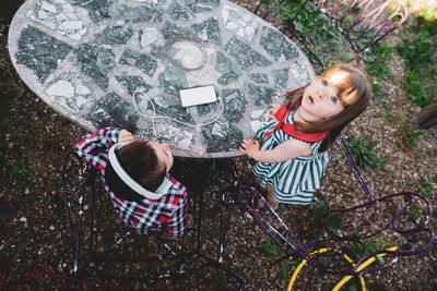 Listening music with sister at table