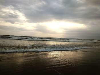 Scenic view of beach against sky during sunset