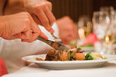 Midsection of man having food in restaurant