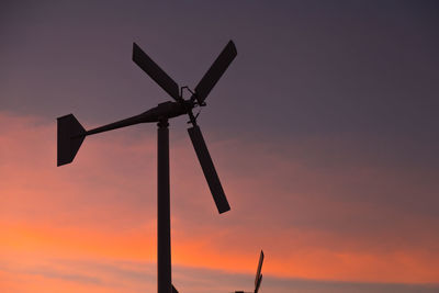 Low angle view of windmill against sky during sunset