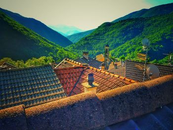 High angle view of houses on mountain against sky