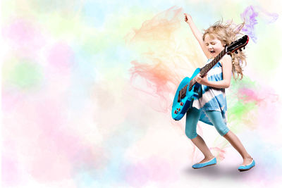 Girl playing guitar over colored background