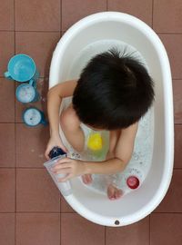 High angle view of child in bathtub