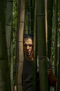 Portrait of man standing in forest