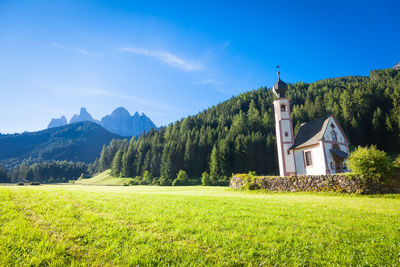 Scenic view of mountains against blue sky