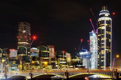 Illuminated buildings in city at night
