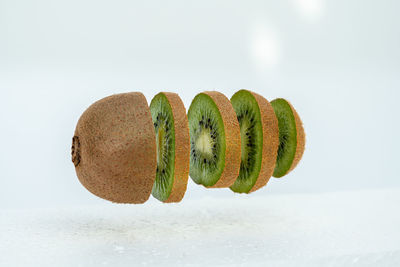 Close-up of fruit on table against white background