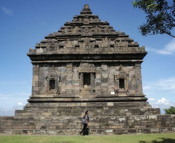 Woman walking outside historic temple