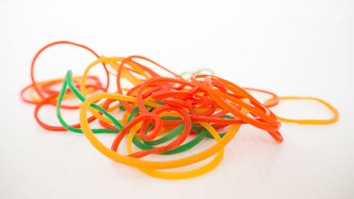 High angle view of multi colored pencils on white background